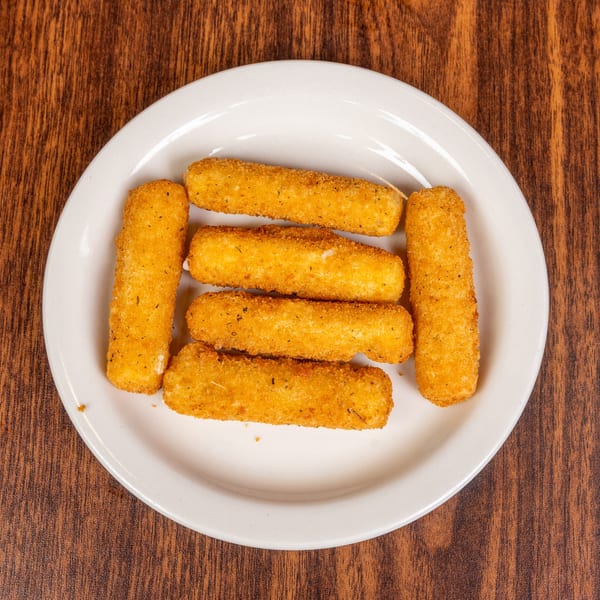 Six golden-brown mozzarella sticks arranged on a white plate on a wooden table.